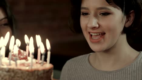 Young-attractive-girl-is-about-to-make-a-wish-and-blow-all-candles