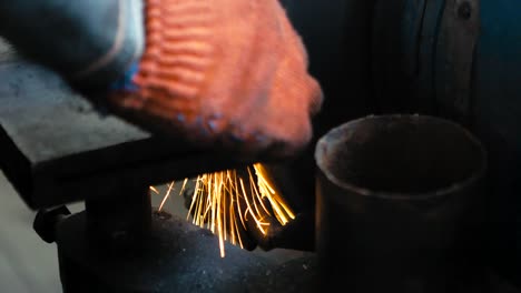 Metal-grinding-on-bench-grinder-with-flying-sparks