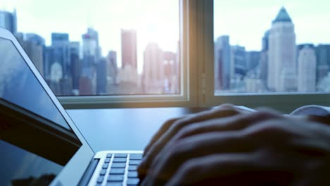 Digital-Device-Computer-with-Business-Figures-and-Banking-District-in-the-Background.