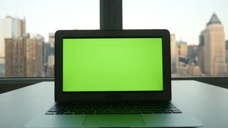 Computer-with-Greenscreen-in-Modern-Office-Building-with-Cityscape-Background.