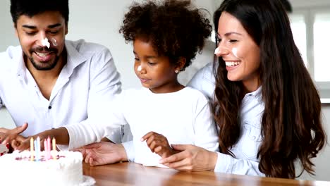 Happy-family-celebrating-birthday-of-their-child