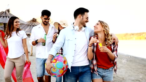 Group-of-happy-friends-partying-on-beach