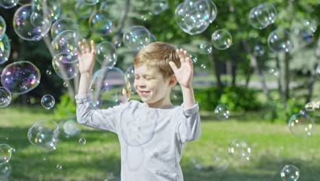 Happy-Blonde-Boy-Enjoying-Soap-Bubbles