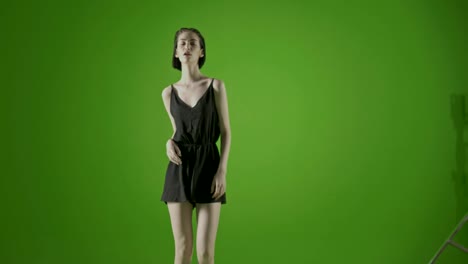 Attractive-girl-,-fashion-model-trendy-and-sensual-dancing-in-a-green-screen