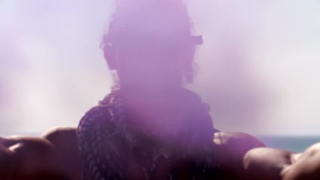 Man-with-steampunk-goggles-and-smoke-bombs-at-the-beach