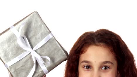 A-close-up-shows-the-top-part-of-the-girl's-face-and-the-way-she-picks-up-the-gift