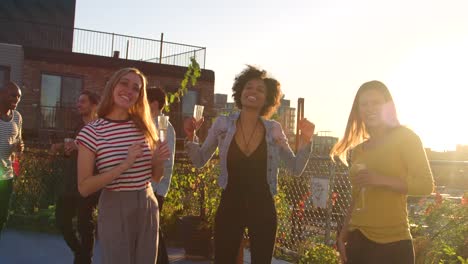 Young-adult-friends-dancing-at-a-party-on-a-Brooklyn-rooftop