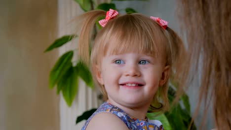 Portrait-of-funny-shy-little-girl-at-home