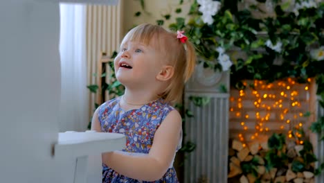 Little-girl-playing-with-white-wooden-rocking-horse