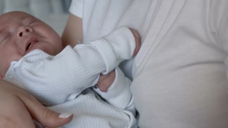 Young-mother-holding-her-newborn-baby.