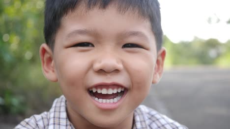 Close-up-little-boy-laughing-and-smile-after-hearing-joke-story