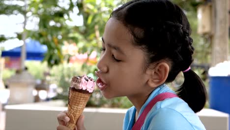 Slow-motion-Asian-little-girl-is-eating-ice-cream-with-happiness