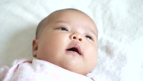 A-Asian-newborn-baby-lay-down-on-white-bed.