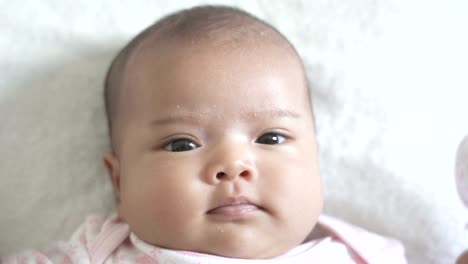 A-Asian-newborn-baby-lay-down-on-white-bed.