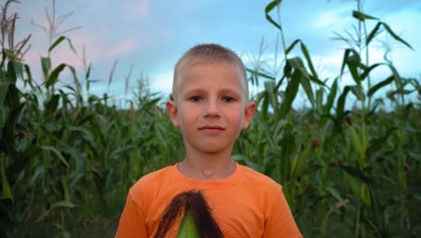 A-boy-with-corn-silk-mustache.-Boy-making-a-mustache-from-corn-hair