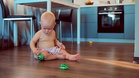 Cute-smiling-girl-playing-on-the-floor-with-toys-and-then-crawling-on-the-floor