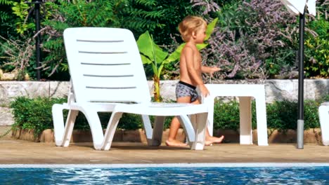 Happy-young-boy-by-the-pool.