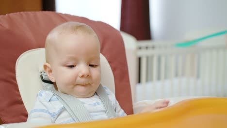 Cute-Baby-Eating-in-the-Chair-at-Home