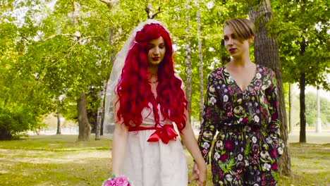 Lesbian-wedding.-The-bride-and-groom-are-walking-in-the-park