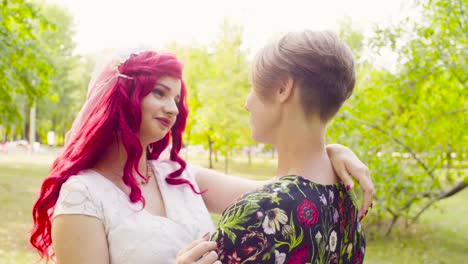 Lesbian-wedding.-The-bride-and-groom-are-hugging-each-other-and-talking