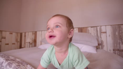 Baby-boy-adventurer-crawling-and-exploring-the-bed