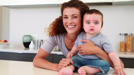 Happy-mother-sitting-with-her-baby-boy