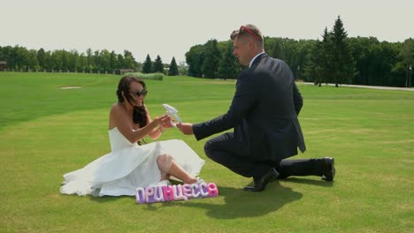 Groom-kneeling-before-bride.