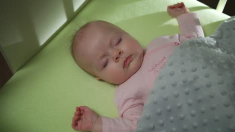 Top-Side-View-of-Sleeping-newborn-baby-dolly-shot-close-up