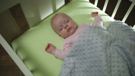 Top-Side-View-of-Sleeping-newborn-baby-dolly-shot-close-up