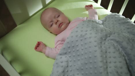 Top-Side-View-of-Sleeping-newborn-baby-dolly-shot-close-up