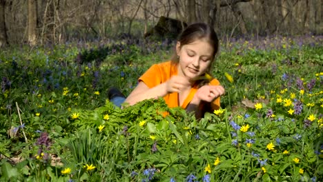 A-teenage-girl-lies-in-a-spring-grass