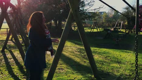 Happy-mother-playing-with-her-toddler-daughter-in-fun-playground