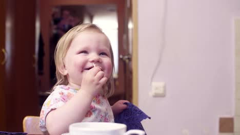 Little-baby-girl-eating-cookies-and-smiling