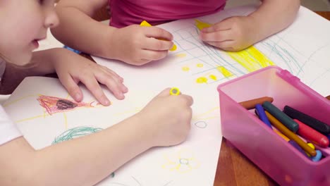 Two-little-girls-drawing-at-a-table