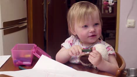 Little-baby-girl-drawing-at-a-table