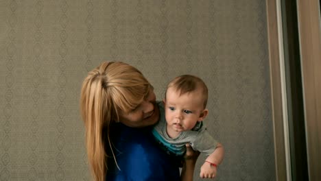 Happy-woman-is-nursing-with-little-boy