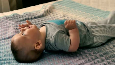 Cute-little-boy-lies-on-the-bed