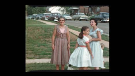 1953-family-posing-with-baby-and-antique-cars