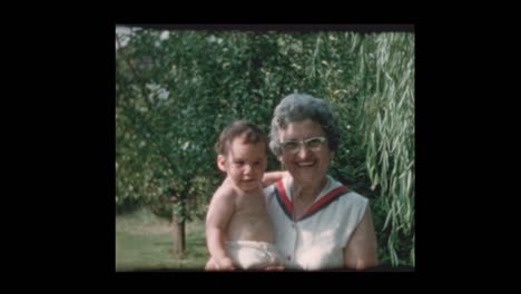 Portrait-of-elderly-grandmother-holding-baby-grandson