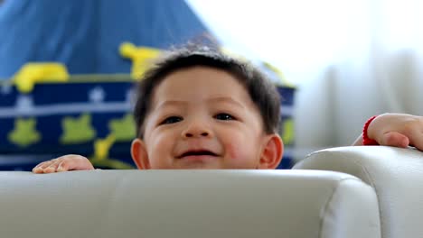 baby-boy-stand-in-fluffy-mattress-partition-in-limit-area-self-protection