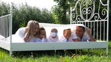 The-family-is-in-white-clothes-on-the-bed