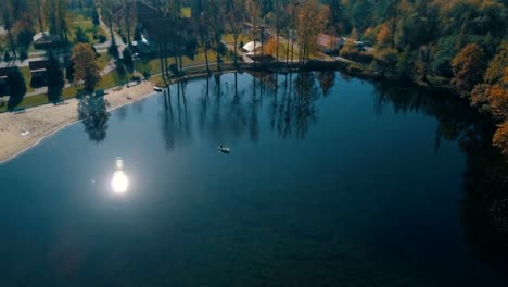 Young-wedding-couple-swimming-on-board-in-beautiful-lake.-Aerial-view