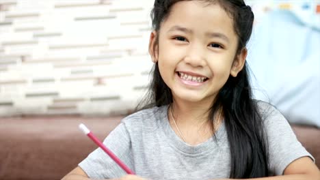 Cute-Asian-little-girl-smiling-with-happiness-with-copy-space-composition