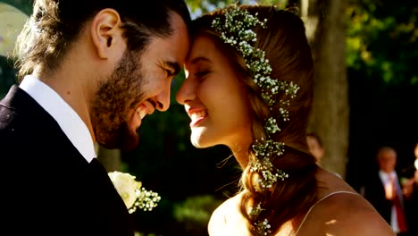 Bride-and-groom-embracing-and-guests-clapping-In-background-4K-4k