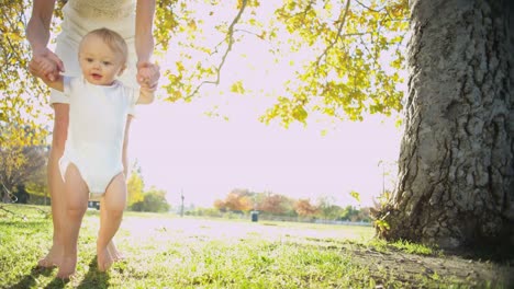 Portrait-of-baby-girl-practicing-her-first-steps