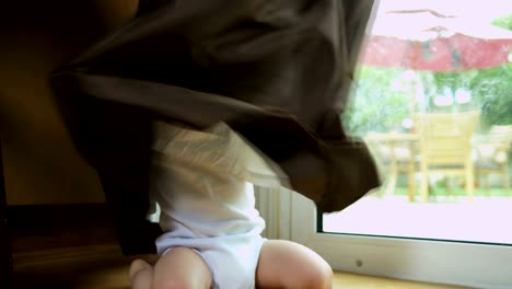 Portrait-of-baby-boy-playing-hide-and-seek