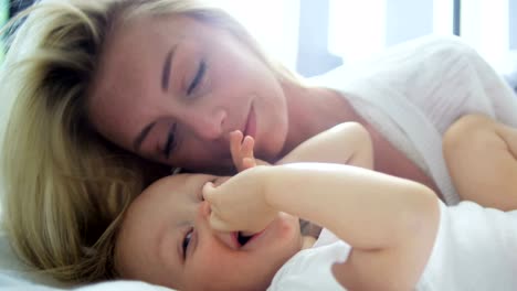 Portrait-of-Caucasian-mother-kissing-her-baby-boy