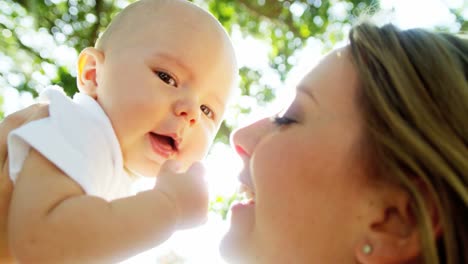 Portrait-of-Caucasian-mother-outdoors-kissing-baby-boy