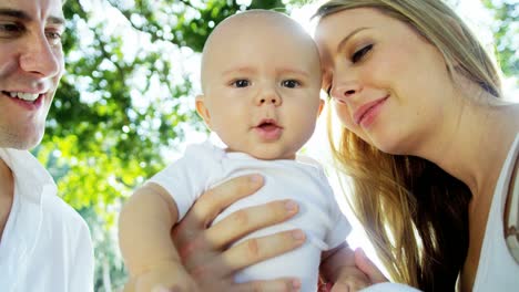 Portrait-of-baby-girl-with-European-parents-outdoors