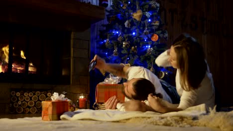 Family-with-baby-taking-selfie-in-Christmas